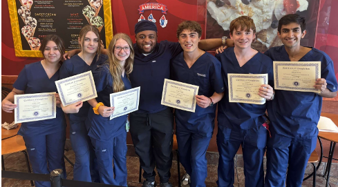 Three seniors are working as Certified Nursing Assistants through the Ozaukee Youth Apprenticeship.  They are Scarlett Wielebski (second from left), Jack Weber (third from right) and Ishan Patil (far right).
